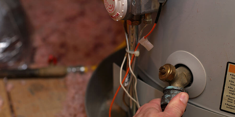 Service technician tightening vault on boiler