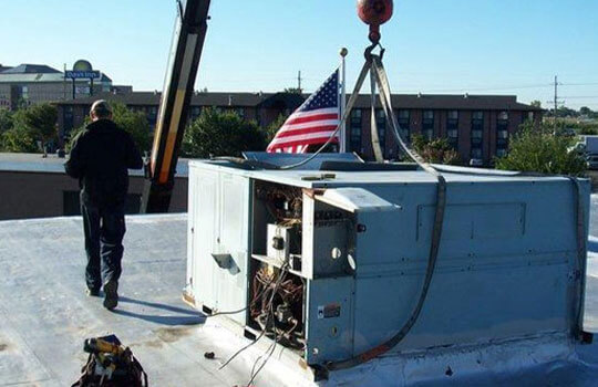 Service Technician Installing Commercial Unit