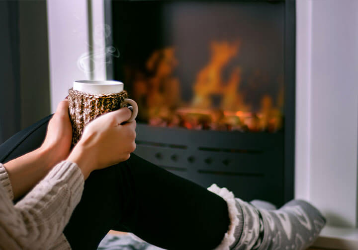 Relaxing next to the fireplace, trying to keep warm