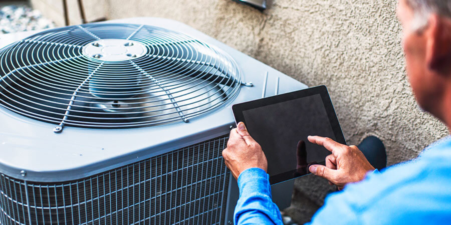 Homeworker reviewing air conditioning repair job